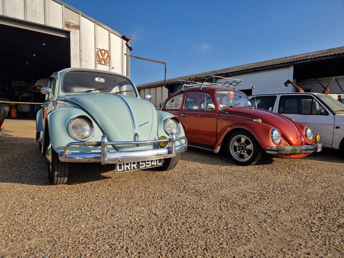 Two classic Beetles outside the workshop