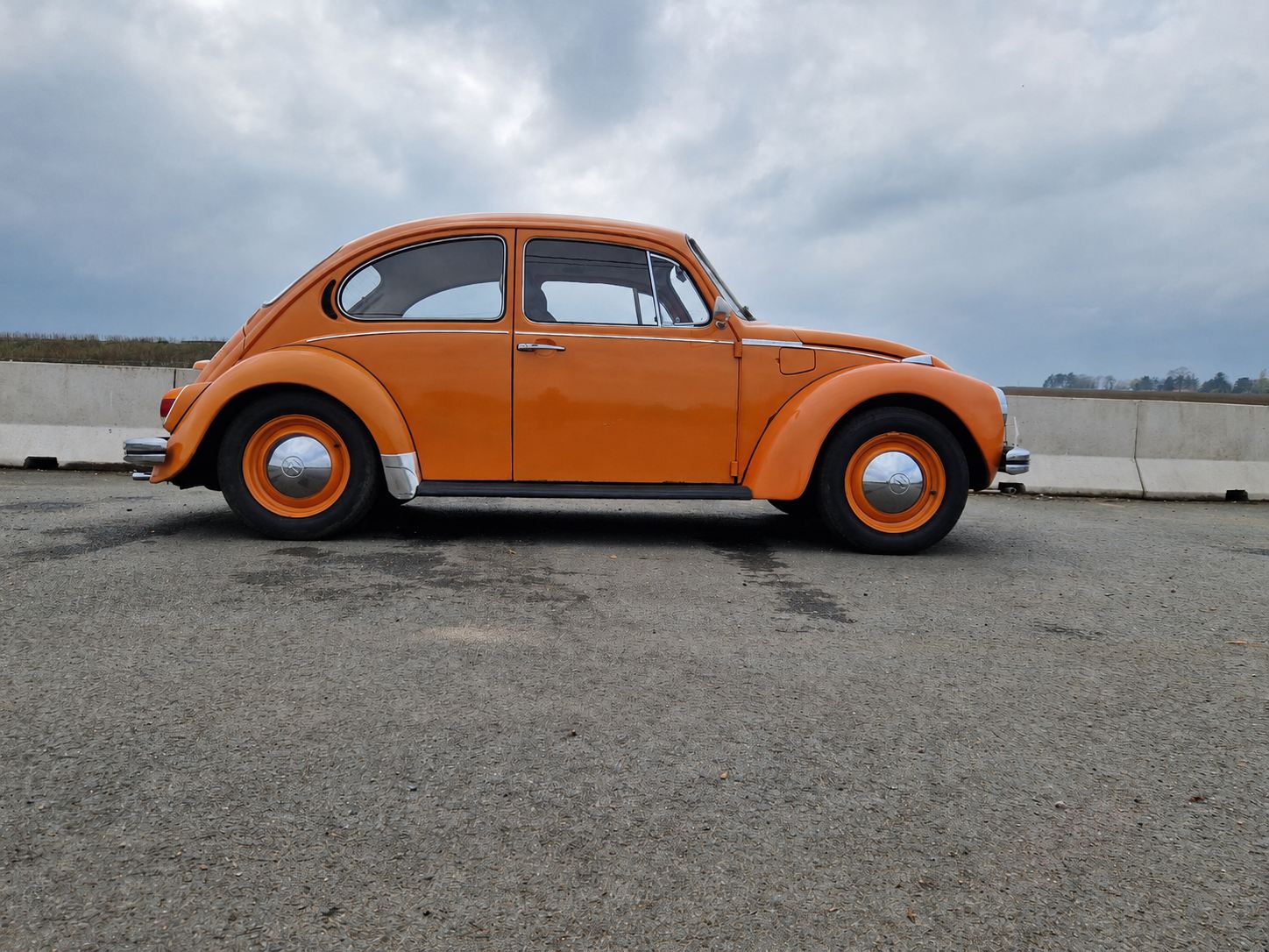 Orange Volkswagen Beetle in profile